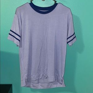 Solid blue T-shirt with stripes on the sleeves.